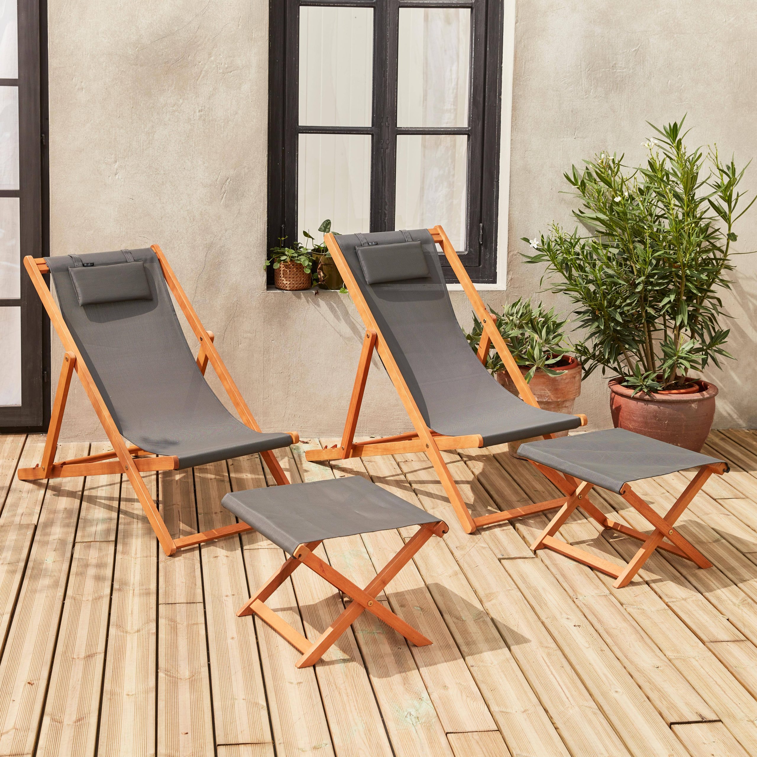 Pair of wooden deckchairs and footrests