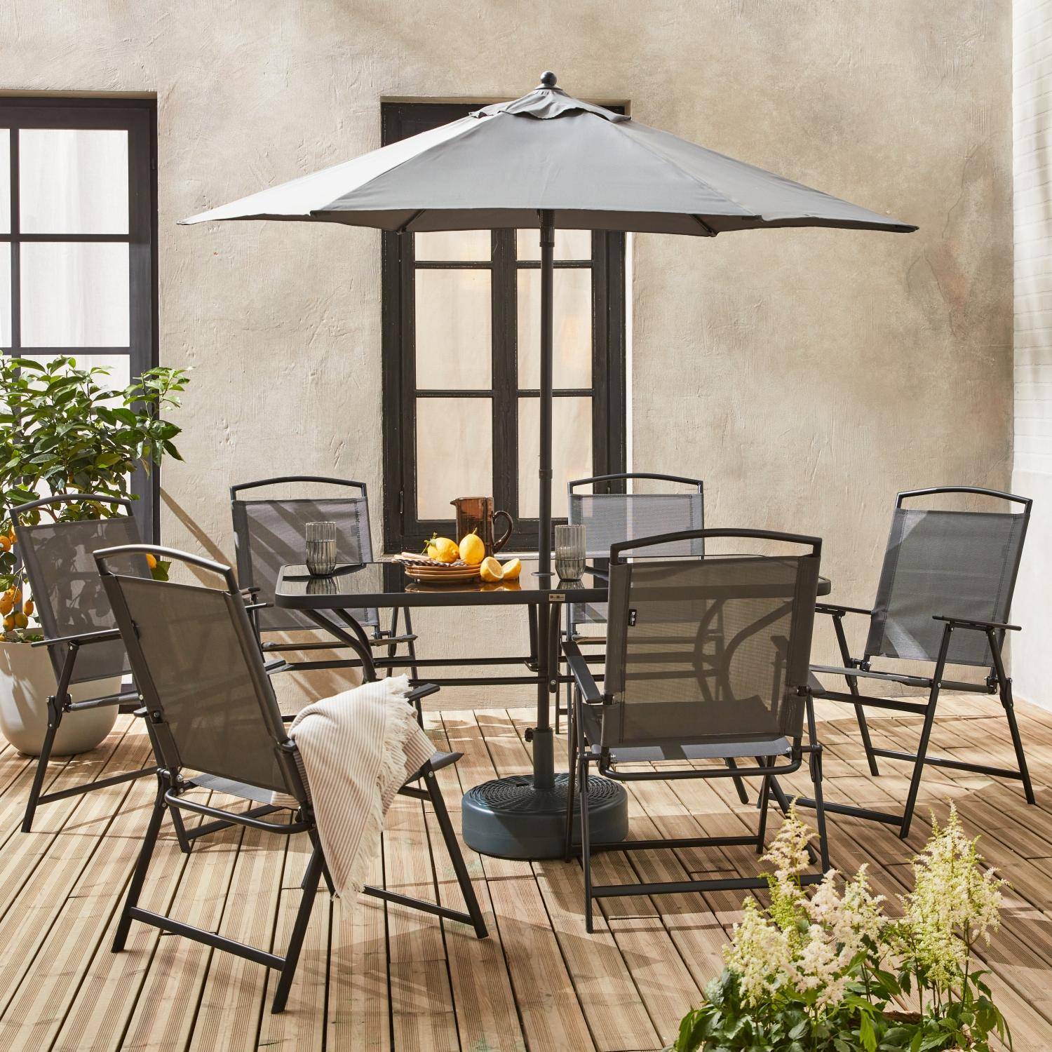 6-seater metal dining set with foldable chairs and parasol